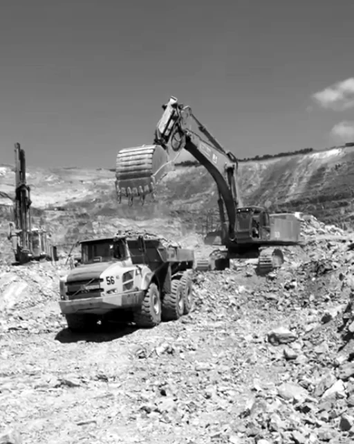 Hitachi EX1900 excavator with its MTG bucket loading an articulated dump truck on a mine in D.R. Congo