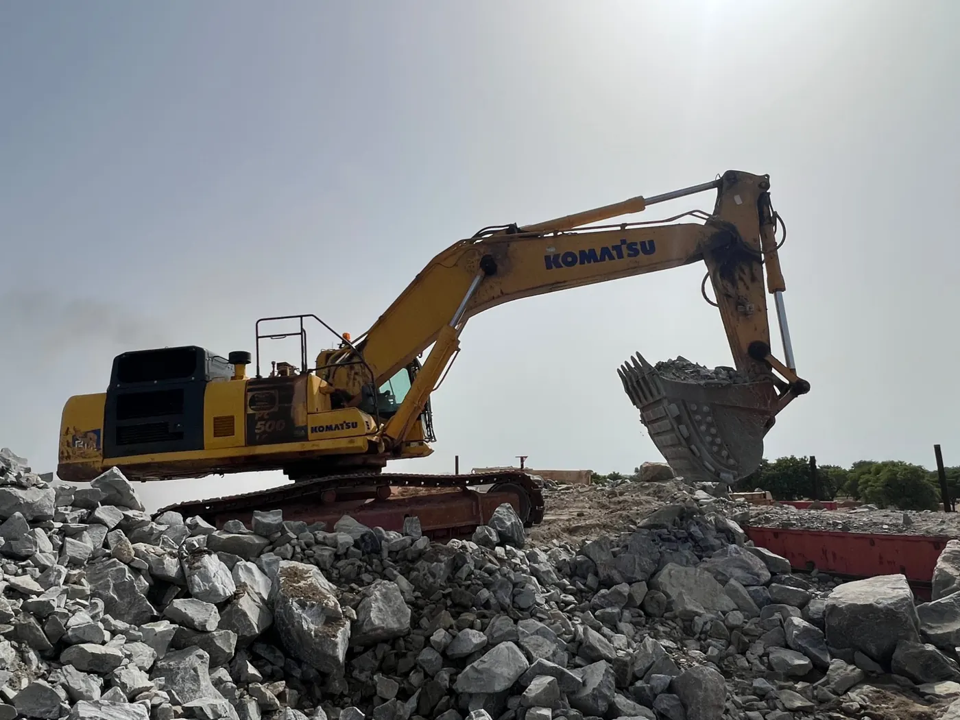 Komatsu PC500 excavator loading rock on a quarry site